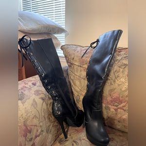 Black 5 inch heeled boots. Laced up back with zipper on the side.